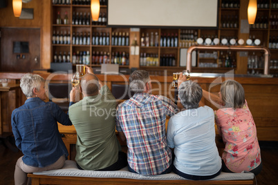 Happy friends having drinks in bar