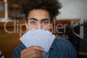 Man showing cards in bar