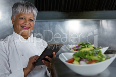 Female chef using digital tablet