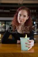 Beautiful waitress holding a drink