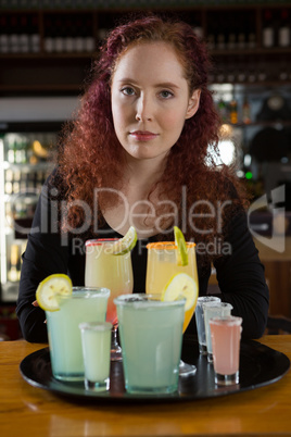 Beautiful waitress holding a drinks