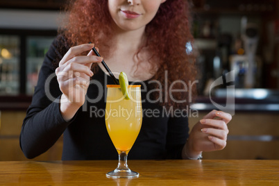 Beautiful waitress making a drink
