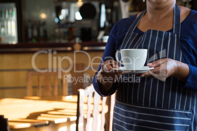 Waitress holding coffee cup