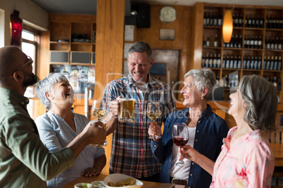 Happy friends having drinks in bar