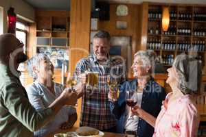 Happy friends having drinks in bar