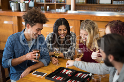 Friends playing backgammon while having drinks in bar