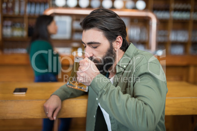 Man drinking glass of beer