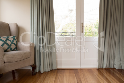 Closed door with sofa on wooden floor in living room