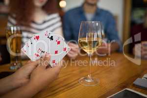 Group of friends playing cards in bar