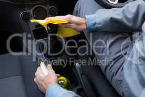 Auto service staff cleaning car interior