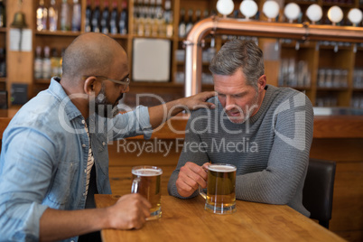 Man comforting his depressed friend