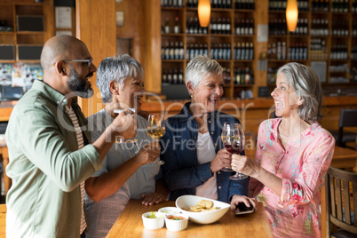 Happy friends having drinks in bar