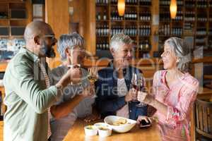 Happy friends having drinks in bar