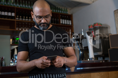 Waiter using mobile phone