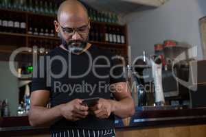 Waiter using mobile phone