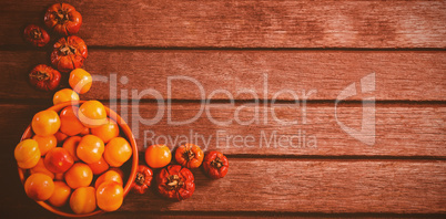 Candies with small pumpkins on wooden table