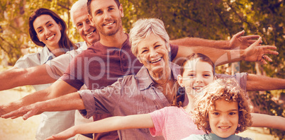 Extended family smiling in park