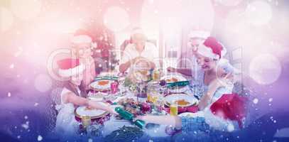 Composite image of cheerful family at dining table for christmas dinner