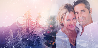 Composite image of couple embracing at christmas
