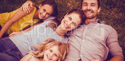Portrait of happy family lying on field