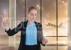 Businesswoman touching air in front of airplane in airport