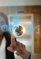 World globe and Businesswoman touching air in front of elevator