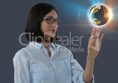 World globe and Businesswoman reaching touching air in front of plants on window