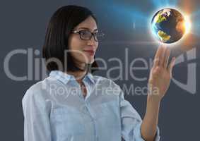 World globe and Businesswoman reaching touching air in front of plants on window