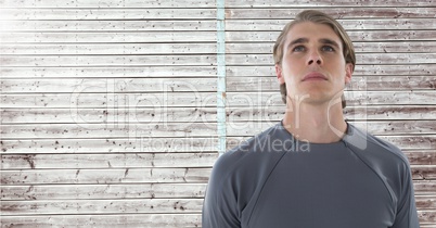 Man looking up with wooden background