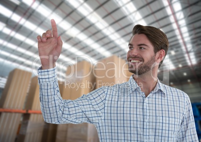 Businessman touching air in front of warehouse