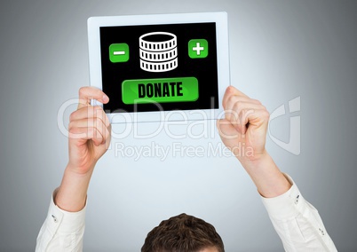 Man holding tablet with donate button and money for charity