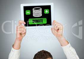 Man holding tablet with donate button and money for charity