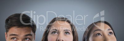 Three people looking up with grey background