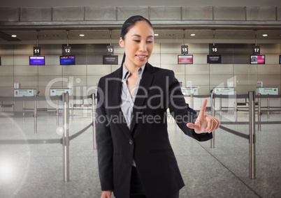 Airport businesswoman touching air in front of airport queue barriers