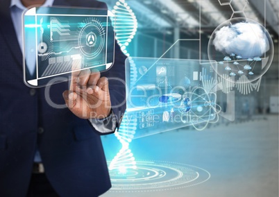 Technology interfaces and Businessman touching air in front of warehouse interior