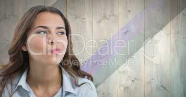 Woman looking suspiciously with wooden background