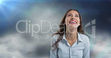 Woman looking up with cloudy background