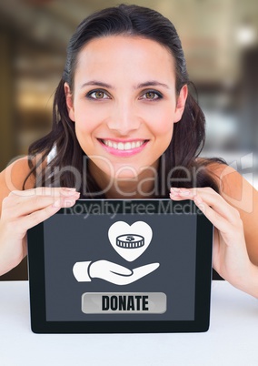 Woman holding tablet with donate button and hand giving heart icon with money for charity