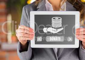 Hand holding tablet with donate button and hand holding money icon for charity