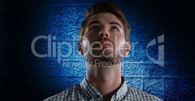 Man looking up with dark blue wall background