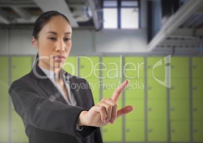 Businesswoman touching air in front of lockers