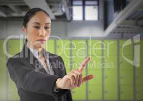Businesswoman touching air in front of lockers