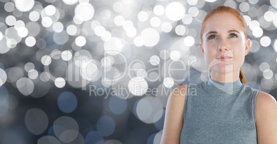 Woman looking up with sparkling background