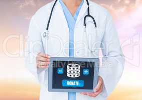 Doctor holding tablet with money donate button and icon for charity
