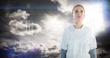 Woman looking up with stadium lights and dark clouds background