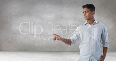 Businessman touching air in front of grey background