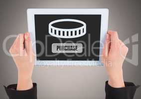 Hand holding tablet with purchase button and money icon