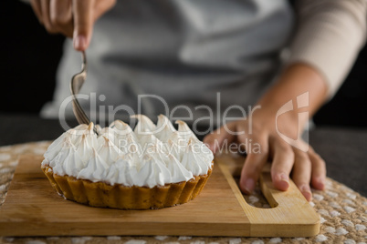 Woman cutting tart with a fork