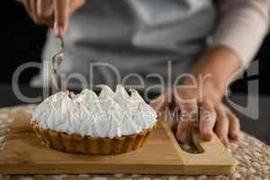 Woman cutting tart with a fork