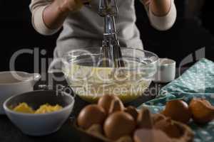 Woman whisking batter in a bowl